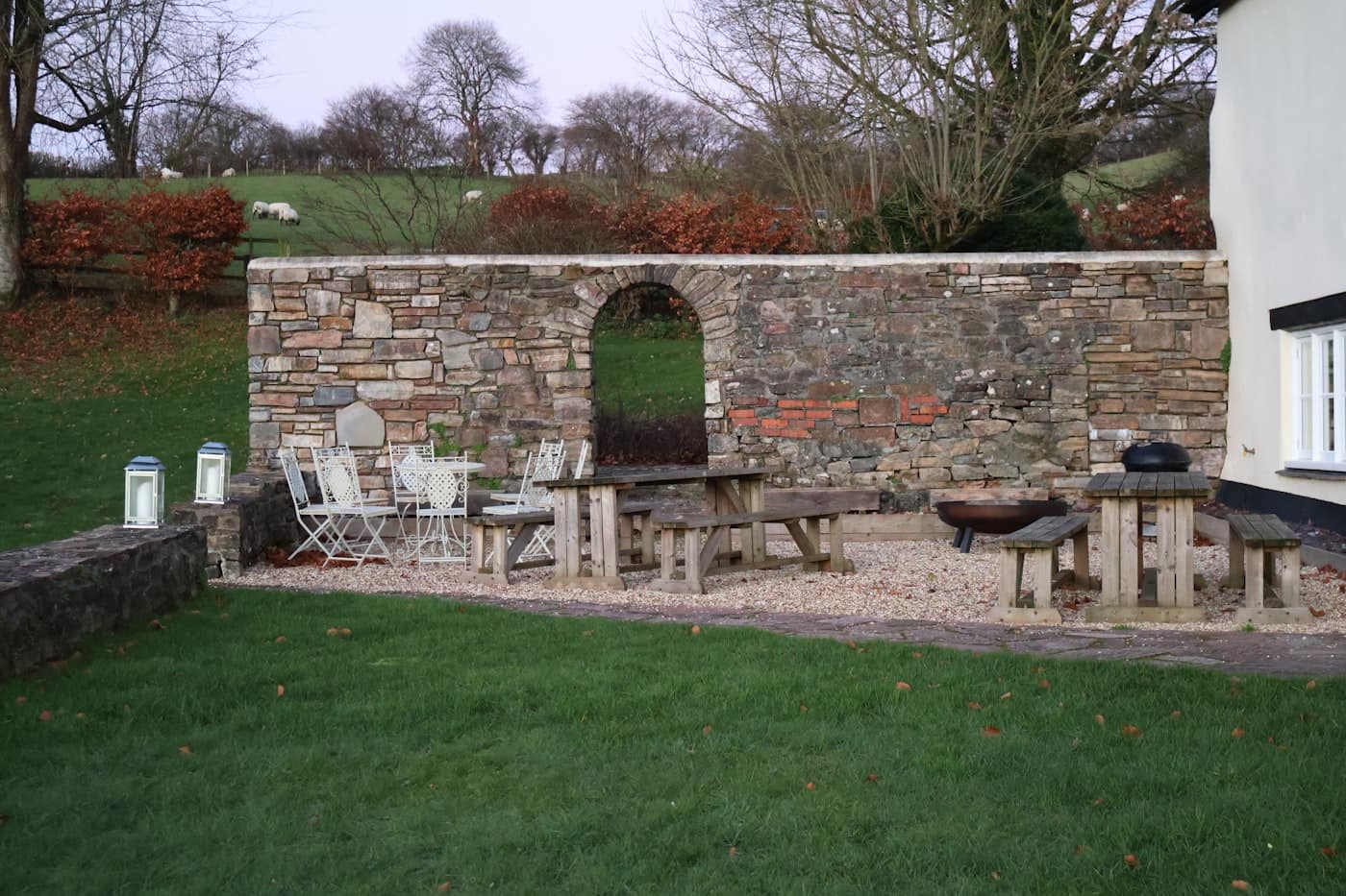 Outdoor patio with evening lighting and stone wall accents